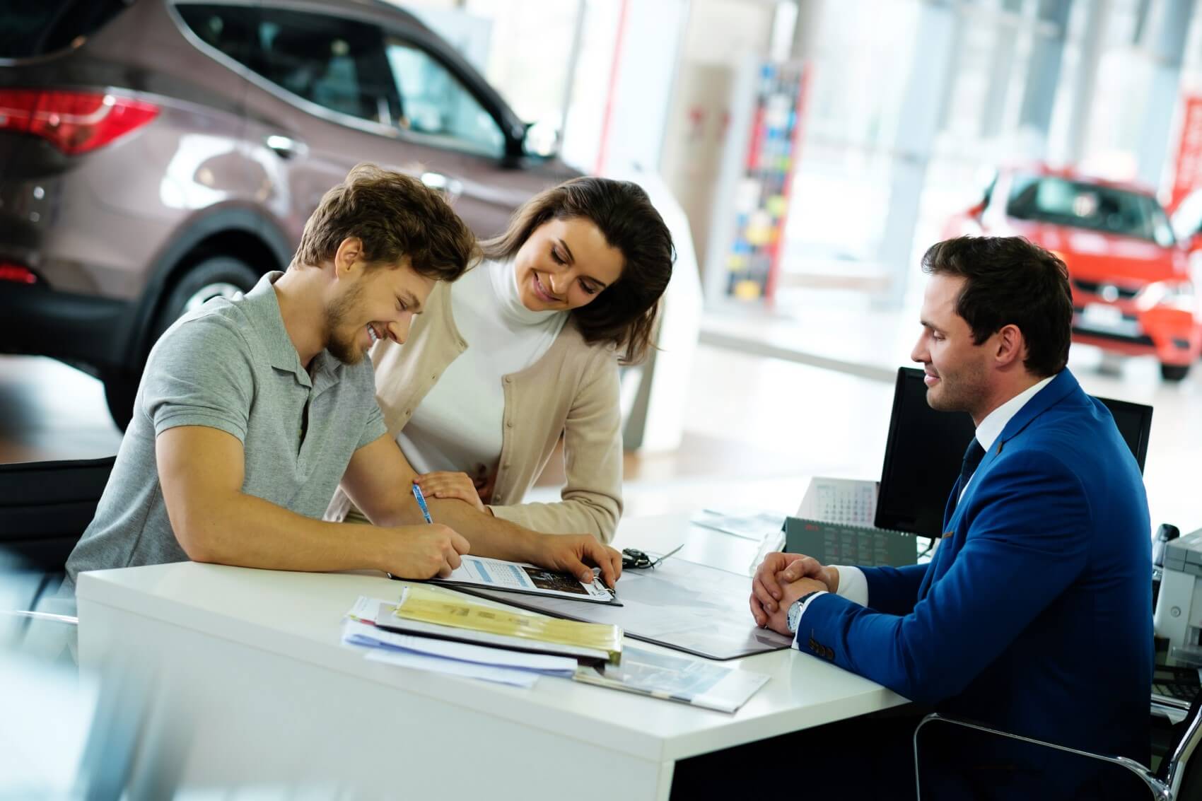 Couple Completing Financing for a New Kia